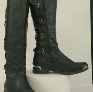 Black faux leather riding boots.